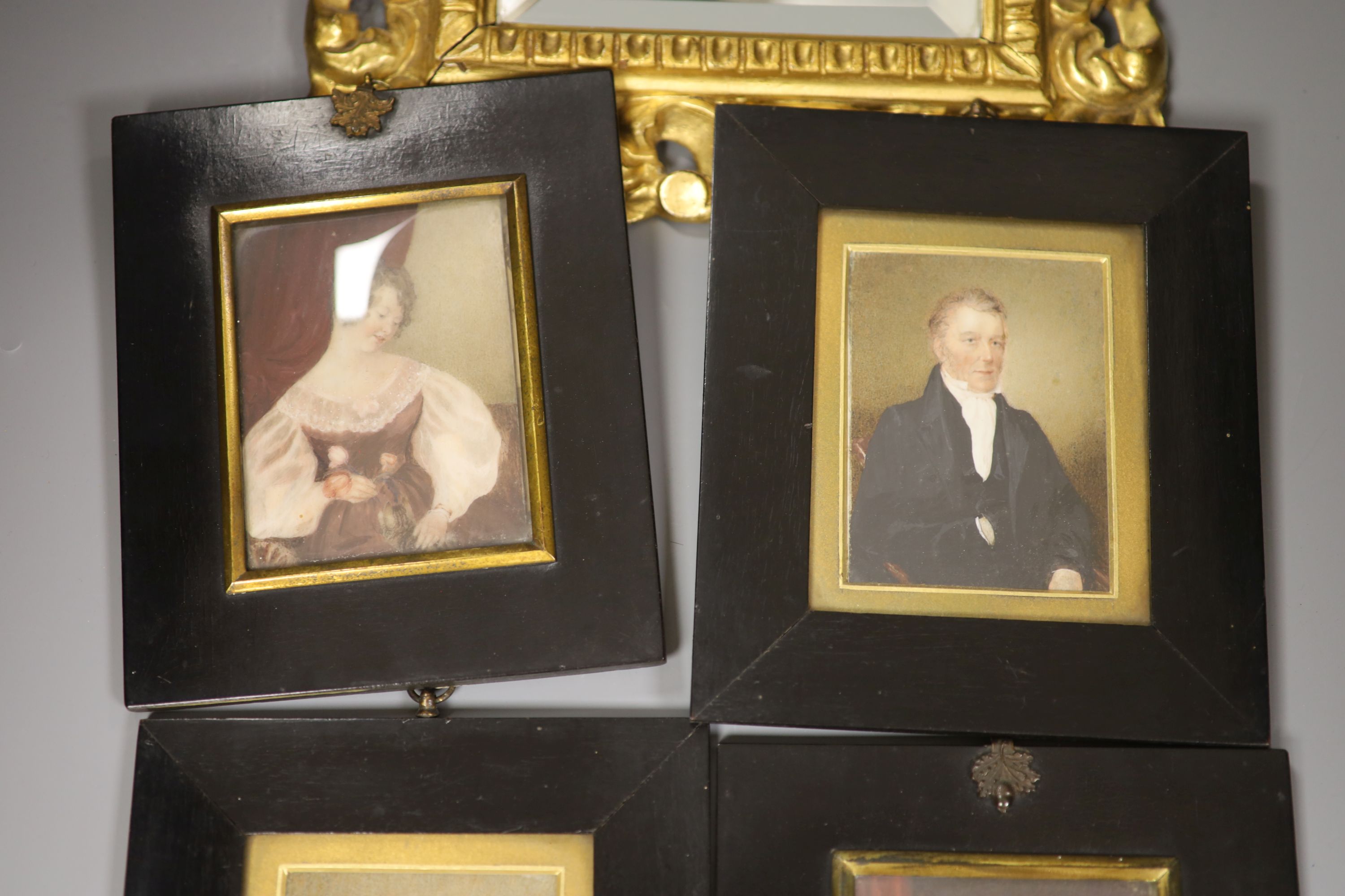 Four 19th century miniature portraits and a gilt-framed mirror, 26 x 29cm